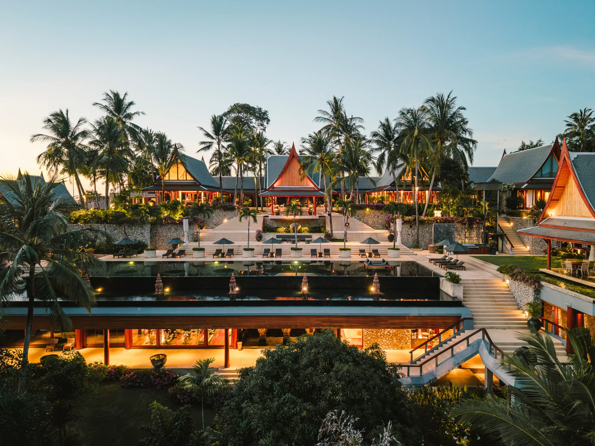 Twilight view of the luxury villa rental Phuket at Chandara Estate, oceanfront pavilions and infinity pool